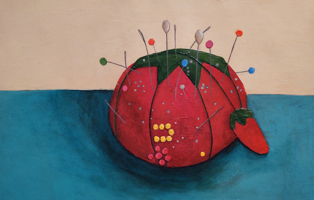 Acrylic painting on paper depicting a cadmium‑red tomato‑shaped pincushion with a small attached strawberry emery, set on a phthalocyanine‑blue (green shade) surface against a buff‑titanium background. The pincushion is studded with colourful plastic ball‑topped pins, metal sewing needles, and small plastic pins arranged in partial shapes, including a visible yellow U‑shaped cluster and red plastic pins forming part of a heart. Thread lines divide the tomato into sections.